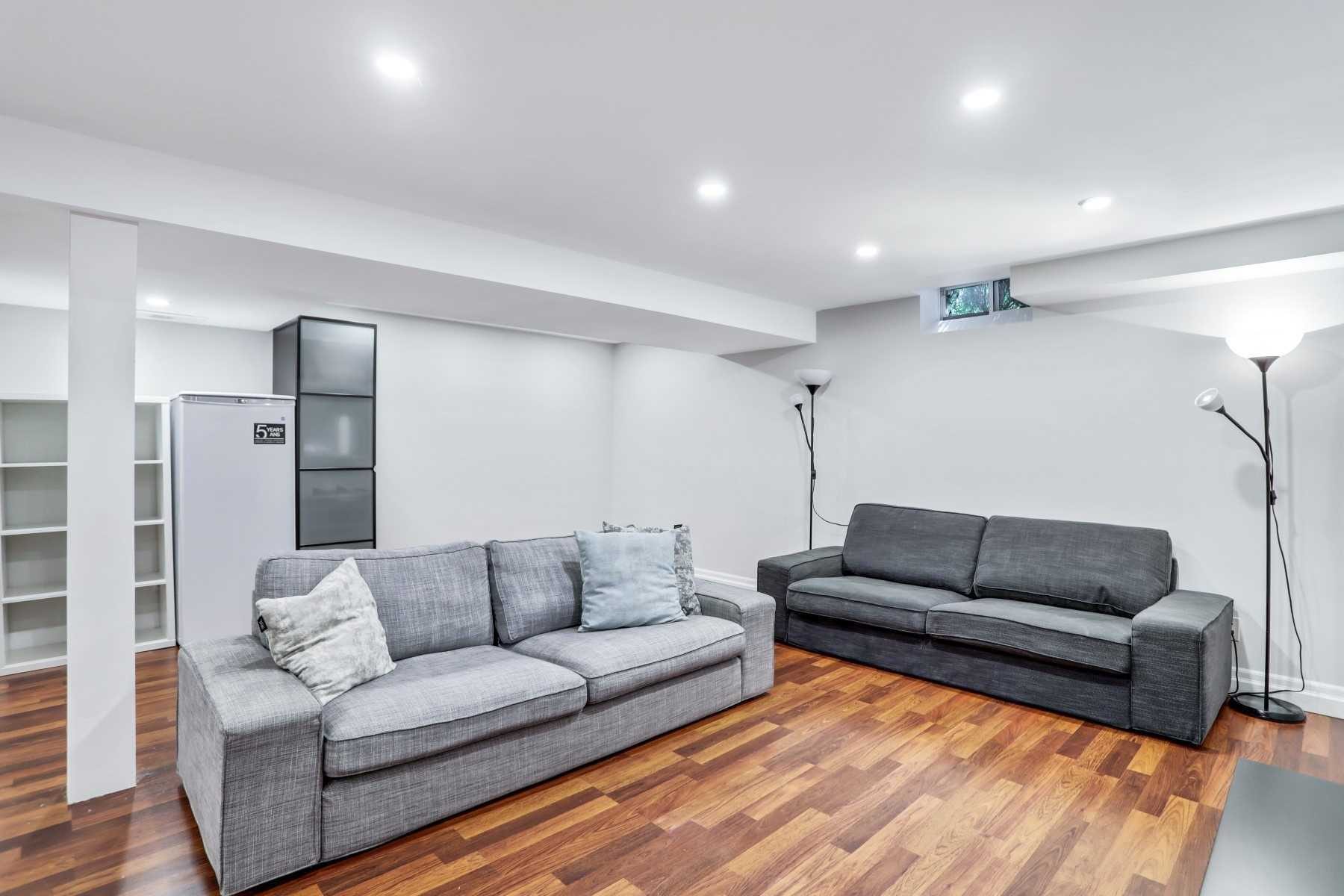 Basement lounge furnished with two grey sofas