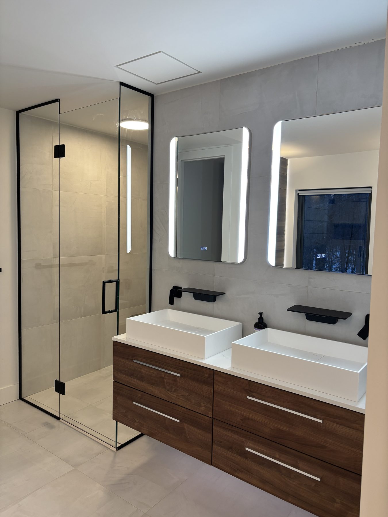 Double vanity and glass shower with black fittings