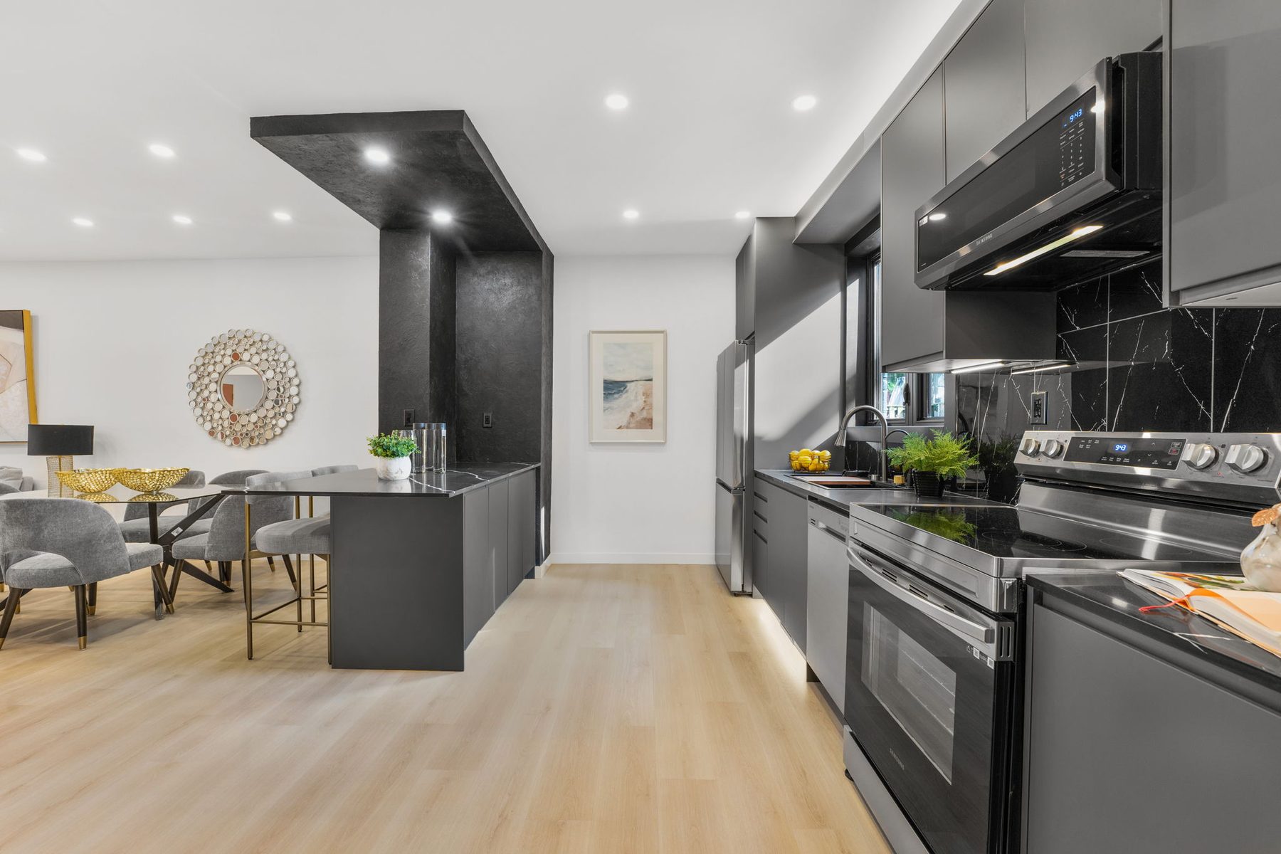Dark contemporary kitchen viewed along the main cabinetry wall