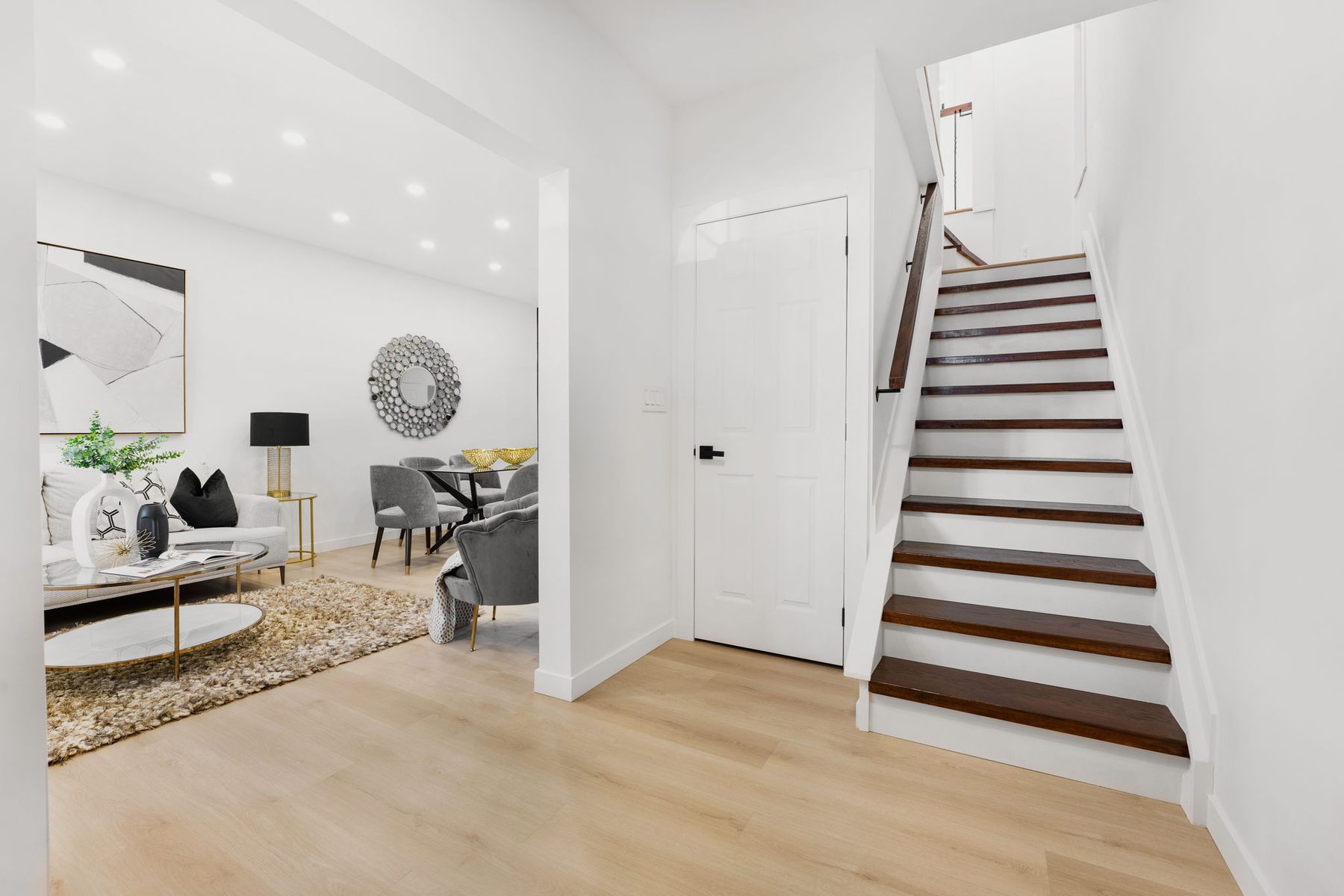 Bright main staircase with dark wood treads