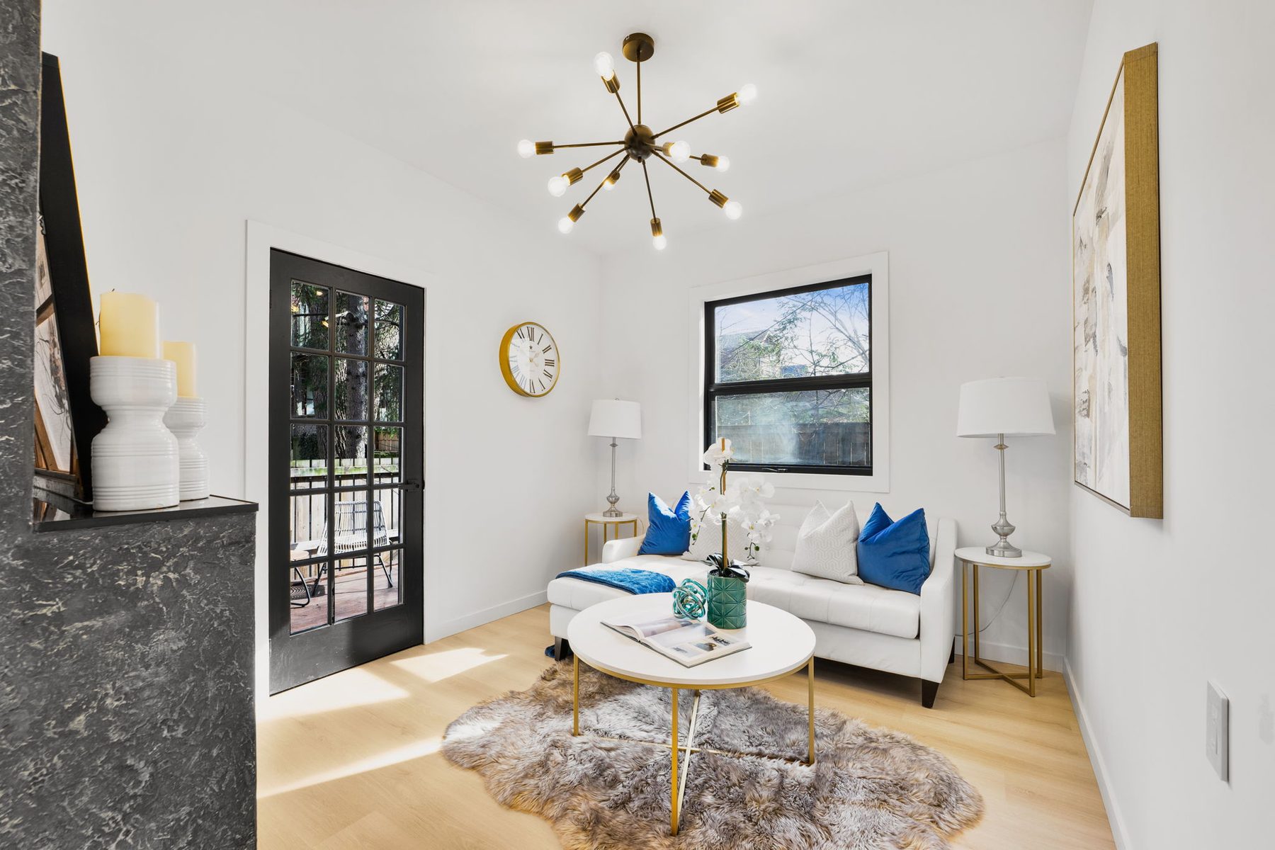 Light-filled living room with fireplace and black-framed windows