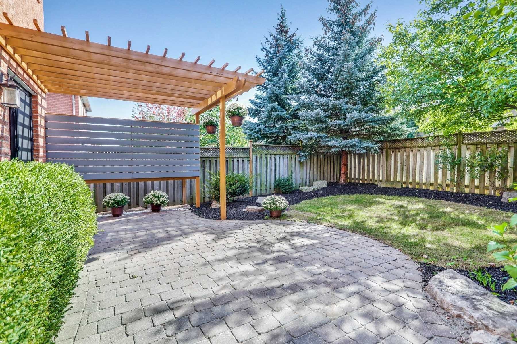 Landscaped backyard patio with a timber pergola