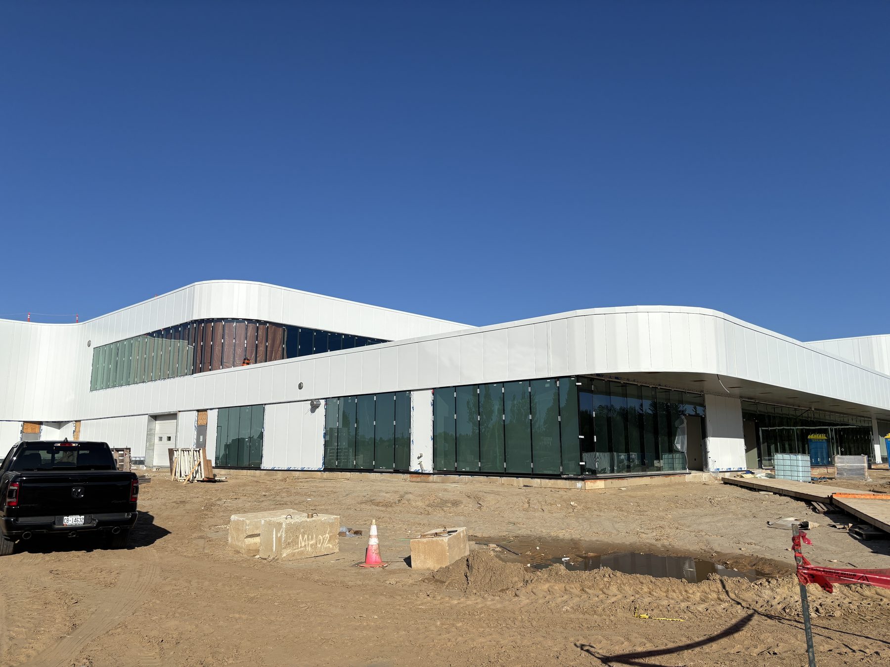 Full exterior view of a curved commercial building with glazing