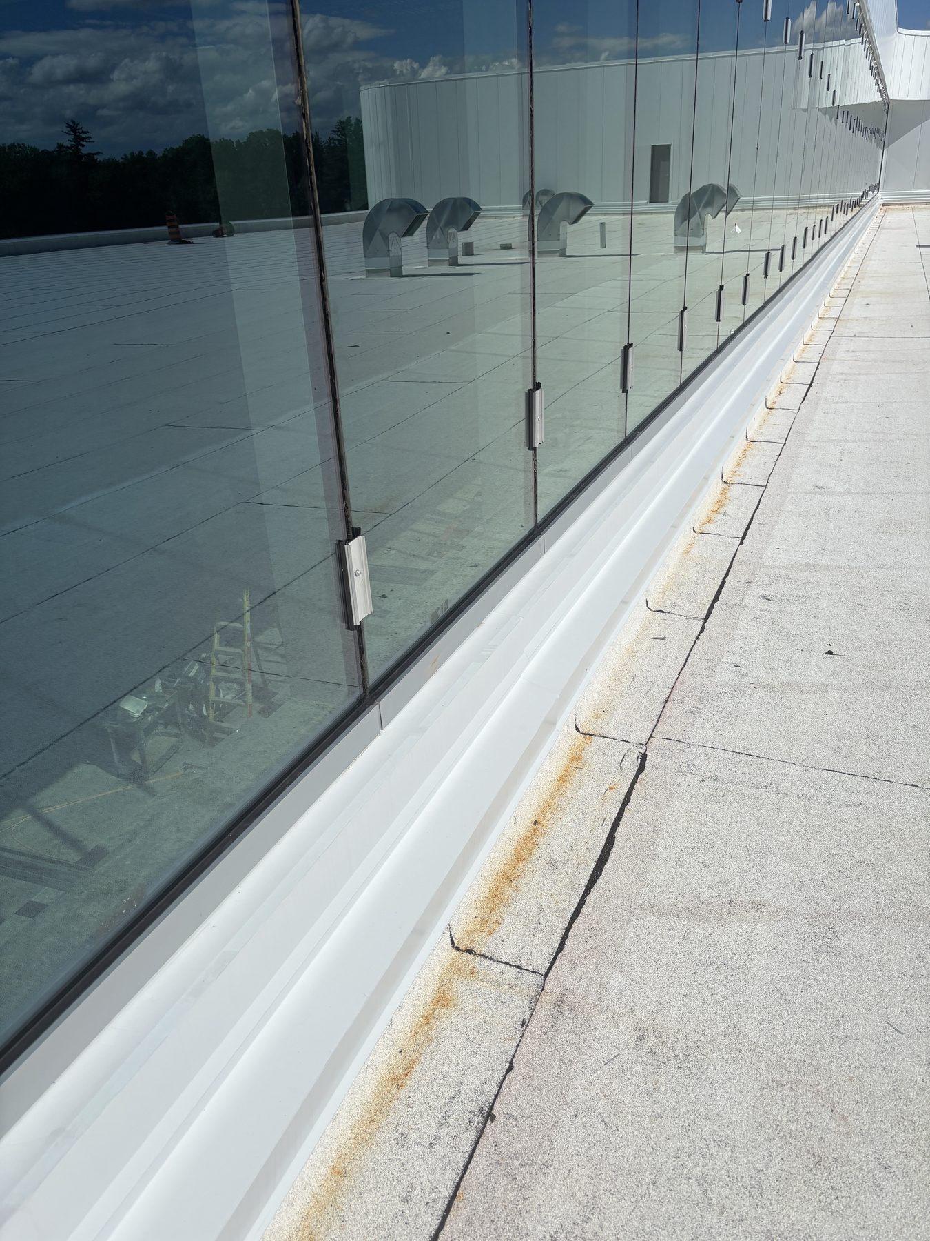 Close-up of a commercial glass wall base connection