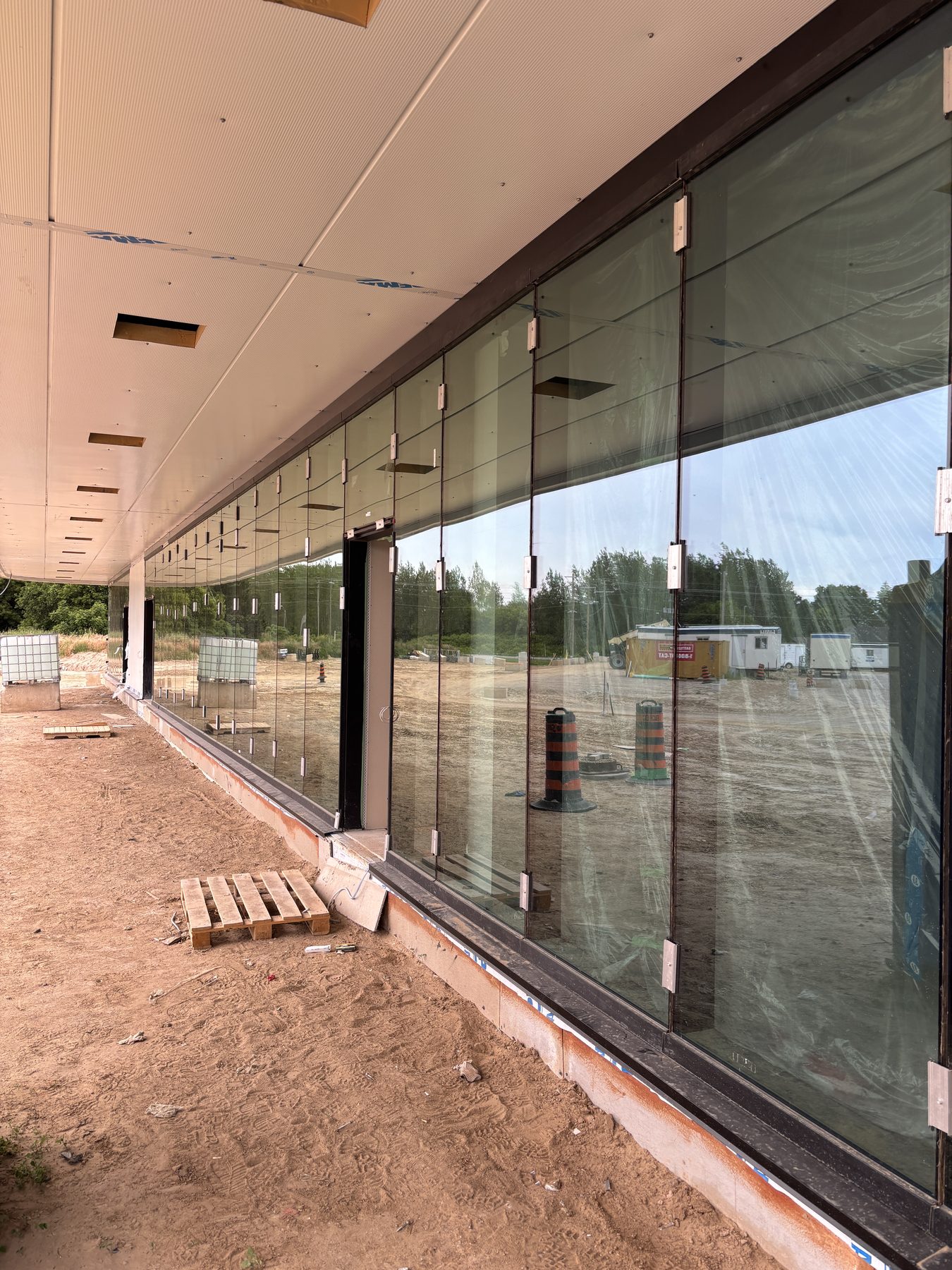 Interior side of a long commercial glass wall installation
