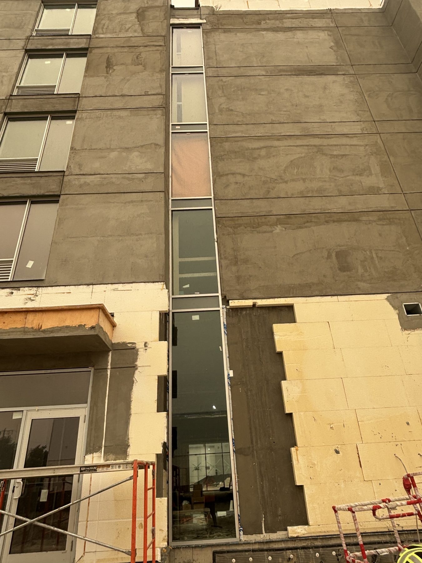 Vertical glass opening installed on a multi-storey façade
