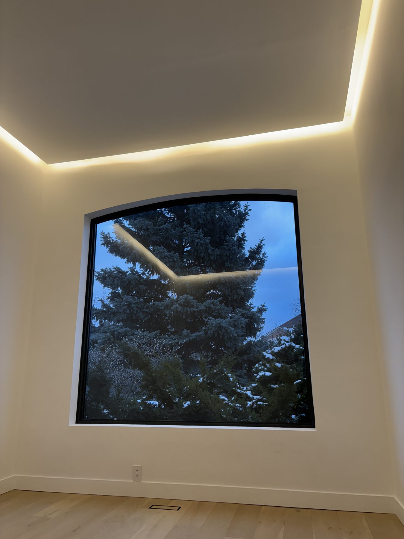 Large feature window framed by an illuminated interior ceiling