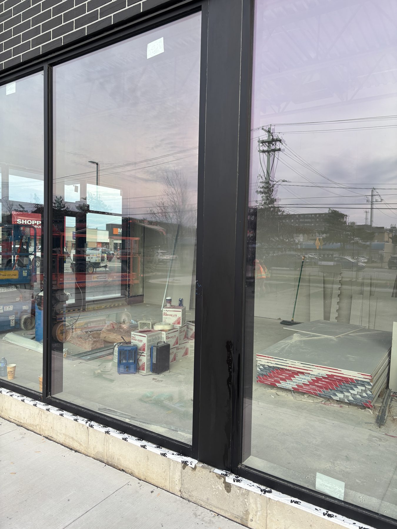 Black-framed storefront glazing viewed from outside